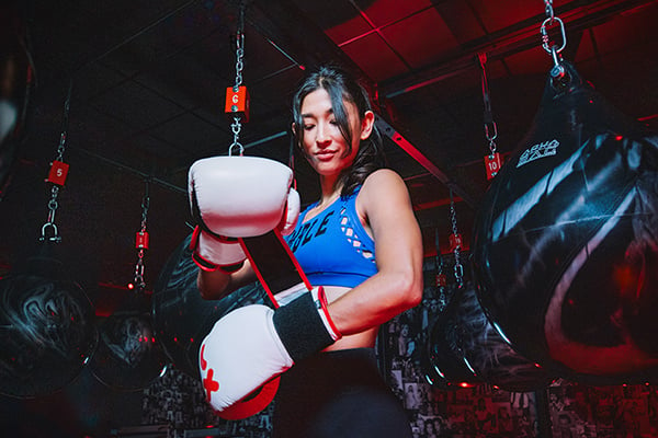 Rumble Boxing trainer Laurel putting on gloves